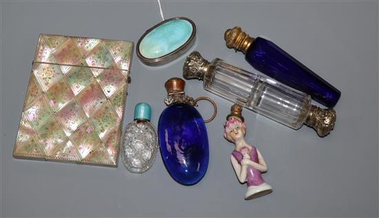 A 1930s silver and enamel pill box, four assorted mounted glass scent bottles and a porcelain lady scent bottle etc.